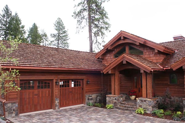Exterior view of a timber home with two car garage.