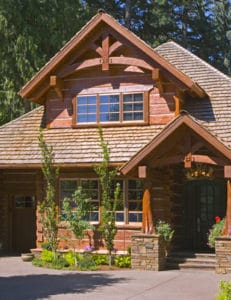 Exterior picture of a beautiful log home with timber arches.