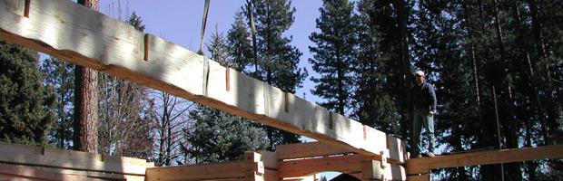 A large beam being reset for a log home build on site.