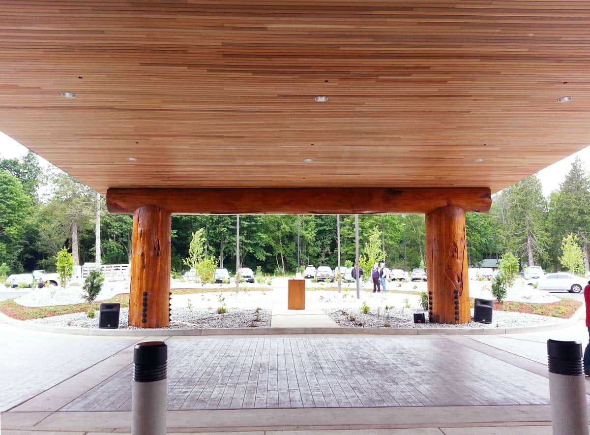 Large portico with wood ceiling and large wooden support beams.
