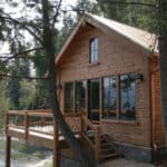 Exterior of a Appalachian Dovetail Log cabin built over a mountain lake.