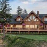 Lovely two story log home (chink-style) settled in the foothills with trees and nice landscaping.
