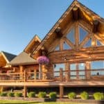 Beautiful chink style log home with large deck and nice landscaping.