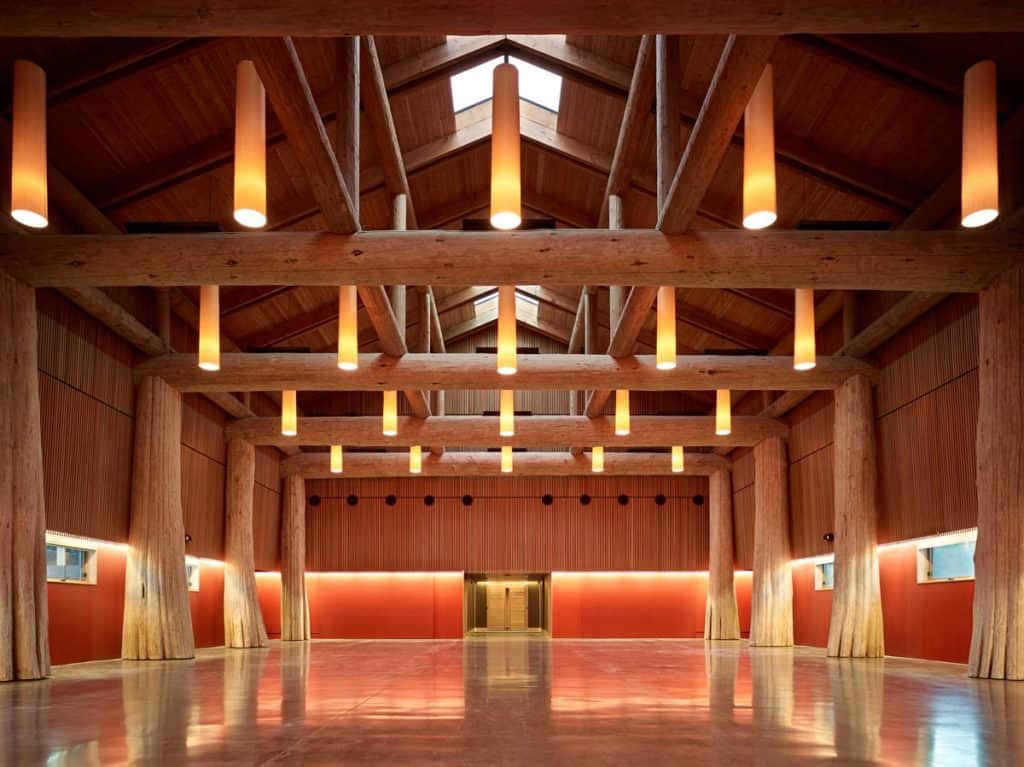 Large room with huge wooden beams and wood supports.