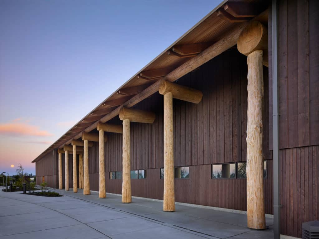Exterior wood siding and large wooden beams on a commercial smokehouse.