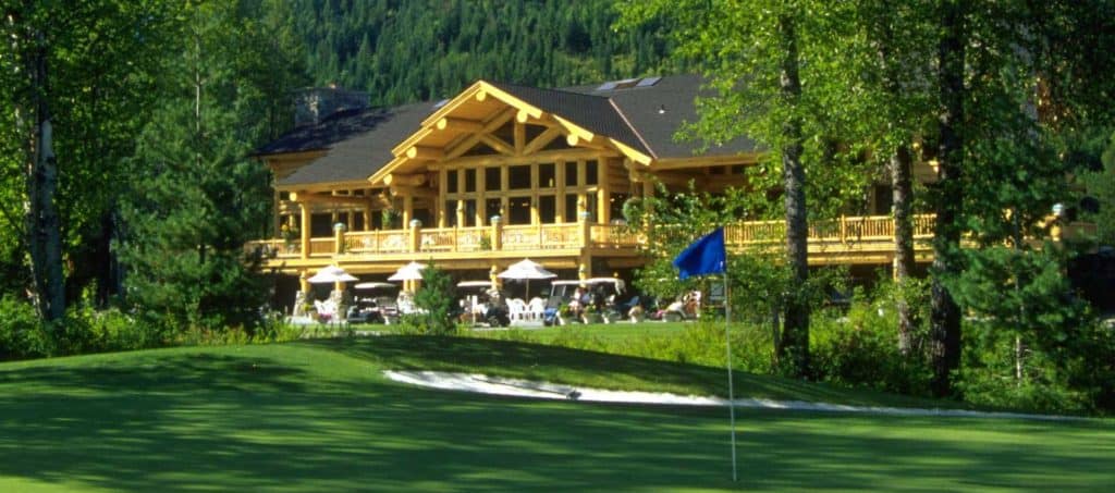 Close angle image of Hidden Lakes Golf Resort exterior. Construction is natural big logs.