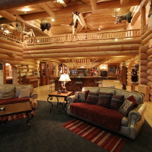 Custom log home great room accented with trophy animals.