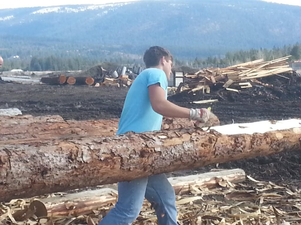 image of a man hand peeling a log