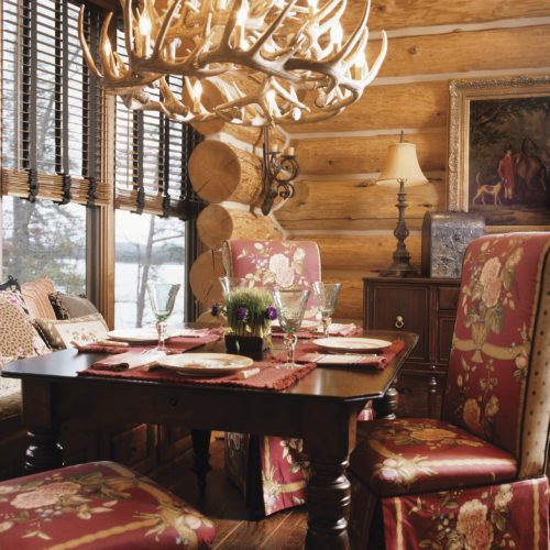 Between the king size chairs, fine art work, and antler chandelier, this dining room seems fit for a King!