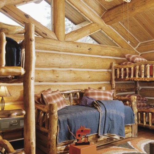 This bunk room is decorated so adorably to give it a cozy 'cabiny' feeling.