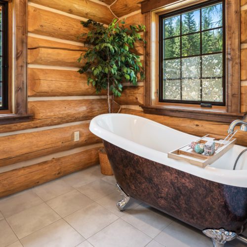 This stellar clawfoot tub is the focal point of this gorgeous log home bathroom.