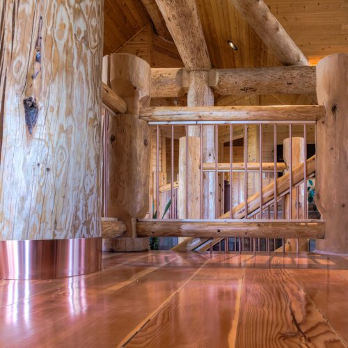 Copper accents such as the log wrap and stair case railings add a bit of bling!