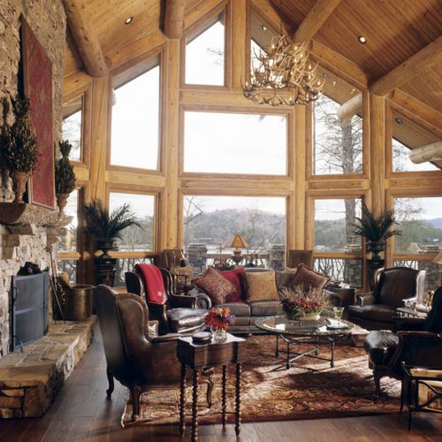 Imagine watching wildlife from this huge window! Leather couches and a plush rug makes this room look inviting.