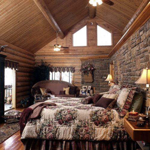 A stone accented pony wall gives a lovely backdrop to this king size bed.