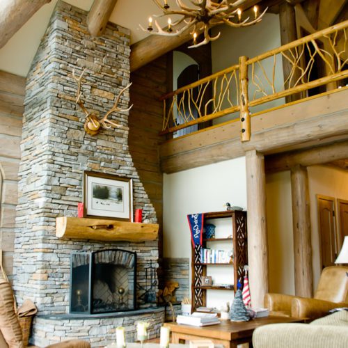 The creative wooden railing is a fine accent piece in this custom log home.