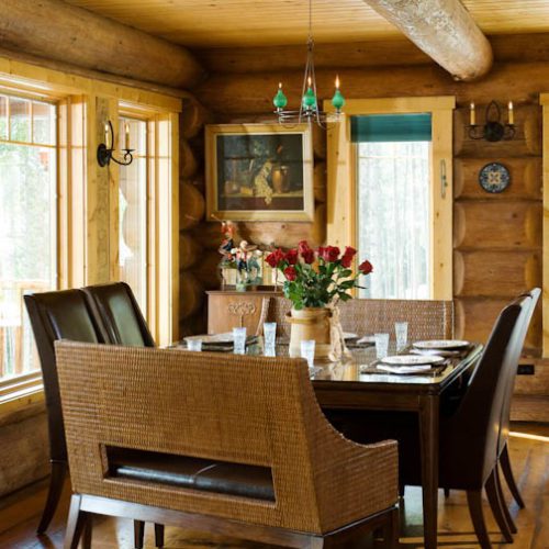 Adorned with a unique dining room table this cabin space has an inviting cottage vibe.