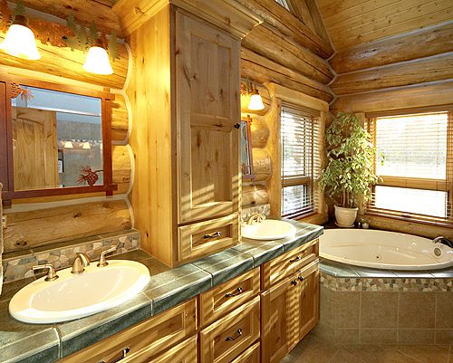 Custom cabinetry accents this log cabin bathroom.