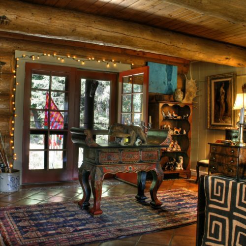 Bold colors and artistic center pieces make this log cabin home a one-of-a-kind.