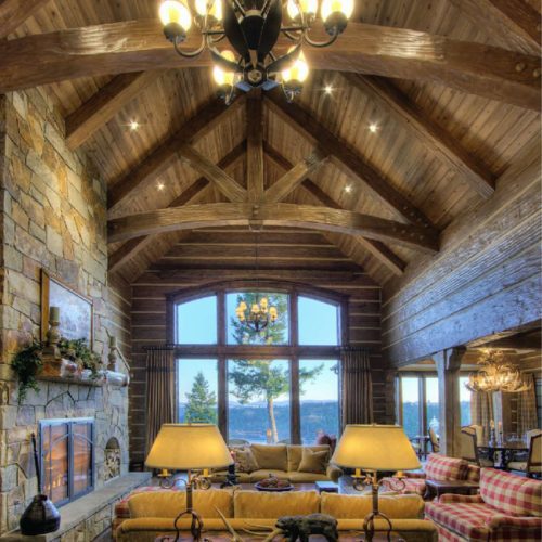 Custom timber trusses accent the handcrafted dovetail logs, giving this home a stately appearance.