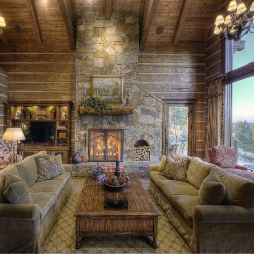 Romantic dovetail log home with huge bay window and cozy fireplace.