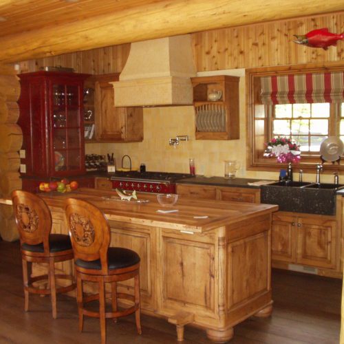 Custom pine cabinetry adds just the right touch to this log home kitchen.