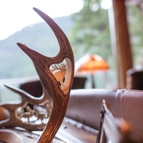 Rustic antler decor such as this hand carved antler sculpture are perfect cabin themed decorations.