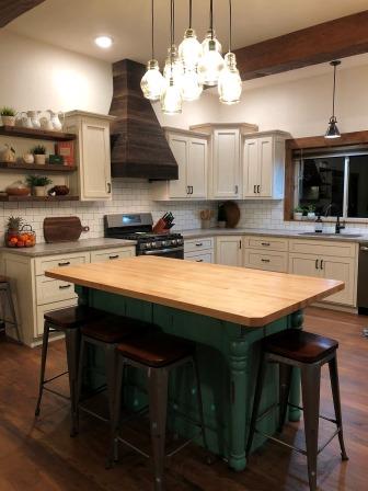 Modern lighting and farmhouse style stools give this timber frame accented home its look.