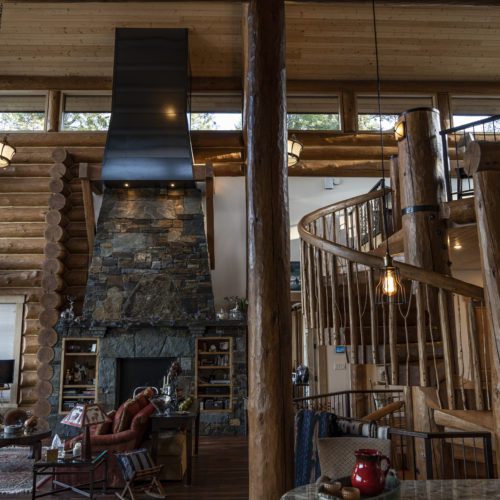 This custom spiral staircase is the focal point of this log home.
