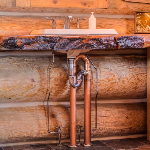 Live edge wooden countertop in log cabin bathroom