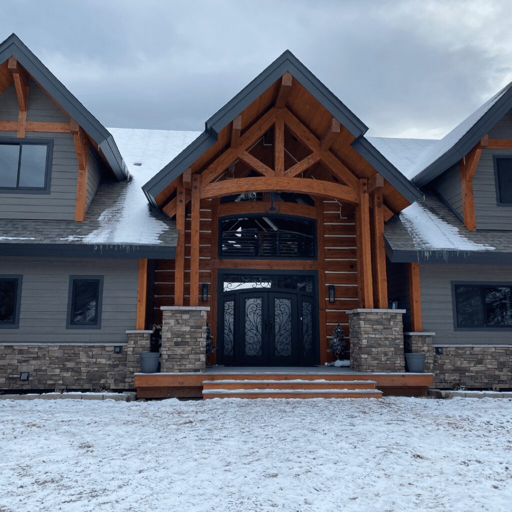 Modern hybrid home with huge arch trusses and dovetail logs